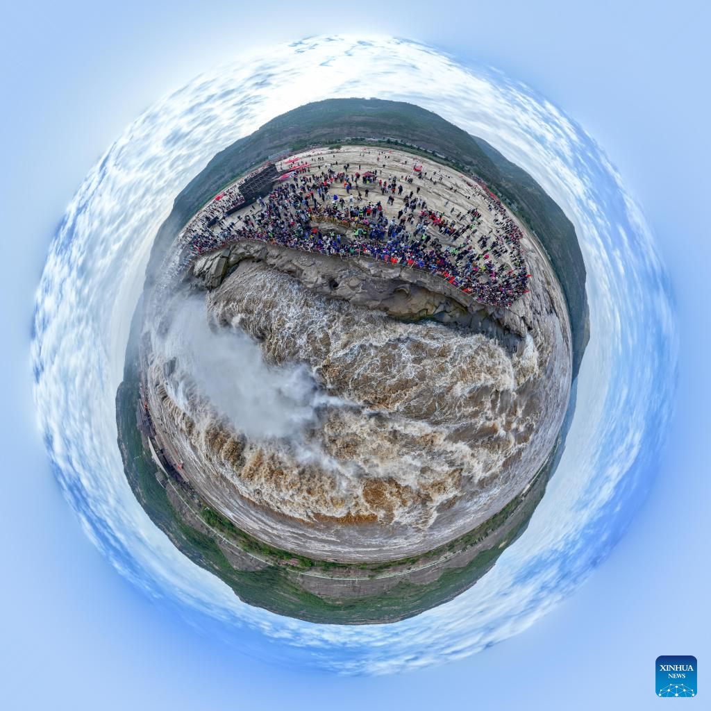 Tourists visit Hukou Waterfall on Yellow River