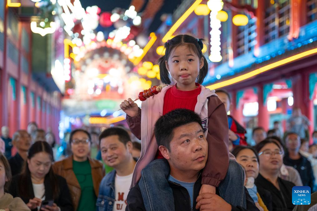 People watch performance at tourist attraction in Hubei