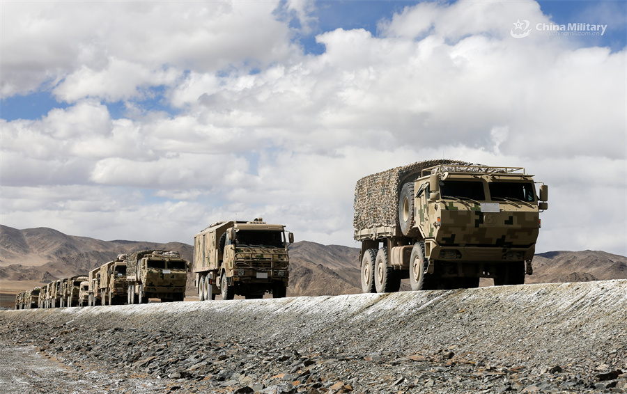 Military vehicles engage in long-distance maneuver exercise